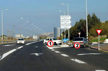 הרכב הלבן (1) שבצומת והרכב הכסוף (2) מתכוונים להיכנס לאותה דרך. מי מהם חייב לתת זכות קדימה?  